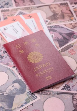 Japanese passport or id document with tickets for flight, travel, border crossing. Japan passport and tickets as a background for your design