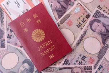 Japanese passport or id document with tickets for flight, travel, border crossing. Japan passport and tickets as a background for your design