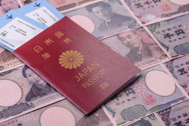 Japanese passport or id document with tickets for flight, travel, border crossing. Japan passport and tickets as a background for your design