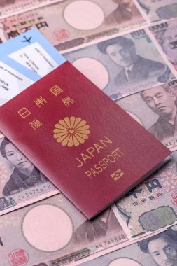 Japanese passport or id document with tickets for flight, travel, border crossing. Japan passport and tickets as a background for your design