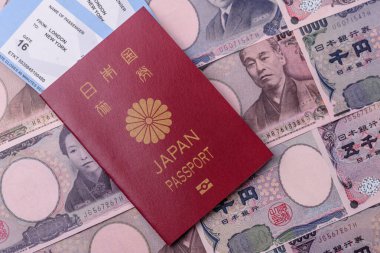 Japanese passport or id document with tickets for flight, travel, border crossing. Japan passport and tickets as a background for your design