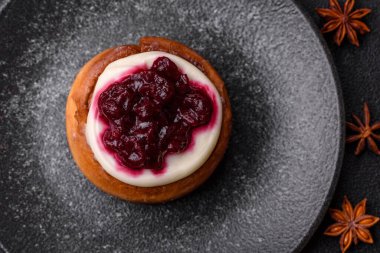 Cinnamon roll, a sweet bun with citrus, cherries, and chocolate, a Danish dessert with cream. Cinnamon roll as a food background for your design