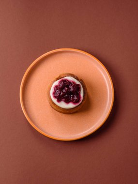 Cinnamon roll, a sweet bun with citrus, cherries, and chocolate, a Danish dessert with cream. Cinnamon roll as a food background for your design