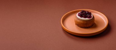 Cinnamon roll, a sweet bun with citrus, cherries, and chocolate, a Danish dessert with cream. Cinnamon roll as a food background for your design