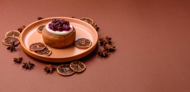 Cinnamon roll, a sweet bun with citrus, cherries, and chocolate, a Danish dessert with cream. Cinnamon roll as a food background for your design