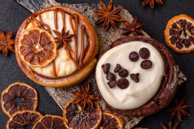 Cinnamon roll, a sweet bun with citrus, cherries, and chocolate, a Danish dessert with cream. Cinnamon roll as a food background for your design