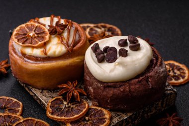 Cinnamon roll, a sweet bun with citrus, cherries, and chocolate, a Danish dessert with cream. Cinnamon roll as a food background for your design