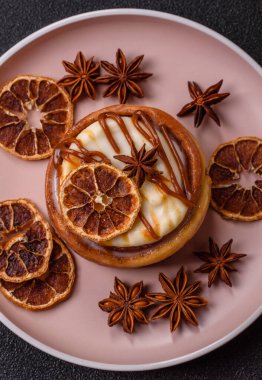 Cinnamon roll, a sweet bun with citrus, cherries, and chocolate, a Danish dessert with cream. Cinnamon roll as a food background for your design