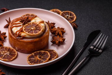 Cinnamon roll, a sweet bun with citrus, cherries, and chocolate, a Danish dessert with cream. Cinnamon roll as a food background for your design