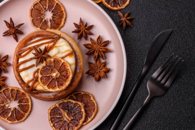 Cinnamon roll, a sweet bun with citrus, cherries, and chocolate, a Danish dessert with cream. Cinnamon roll as a food background for your design