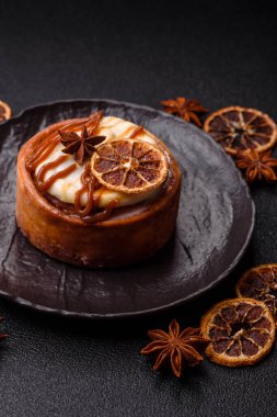 Cinnamon roll, a sweet bun with citrus, cherries, and chocolate, a Danish dessert with cream. Cinnamon roll as a food background for your design