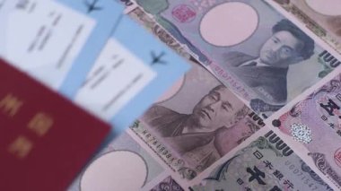 Japanese passport or id document with tickets for flight, travel, border crossing. Japan passport and tickets as a background for your design