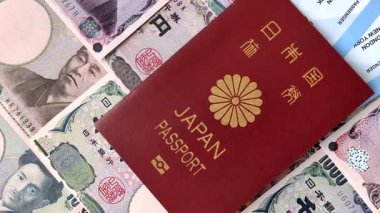 Japanese passport or id document with tickets for flight, travel, border crossing. Japan passport and tickets as a background for your design