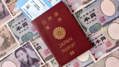 Japanese passport or id document with tickets for flight, travel, border crossing. Japan passport and tickets as a background for your design