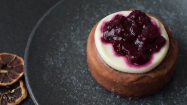 Cinnamon roll, a sweet bun with citrus, cherries, and chocolate, a Danish dessert with cream