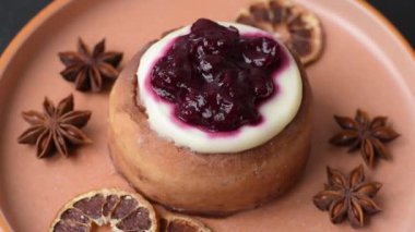 Cinnamon roll, a sweet bun with citrus, cherries, and chocolate, a Danish dessert with cream