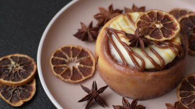 Cinnamon roll, a sweet bun with citrus, cherries, and chocolate, a Danish dessert with cream