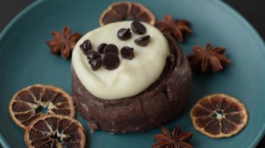 Cinnamon roll, a sweet bun with citrus, cherries, and chocolate, a Danish dessert with cream