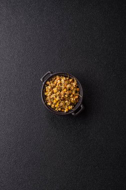 Dried chamomile flowers, herbal tea in a bowl for a hot morning drink. Dried chamomile as a background for your design.