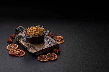 Dried chamomile flowers, herbal tea in a bowl for a hot morning drink. Dried chamomile as a background for your design.