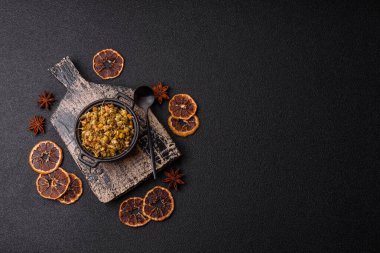 Dried chamomile flowers, herbal tea in a bowl for a hot morning drink. Dried chamomile as a background for your design.