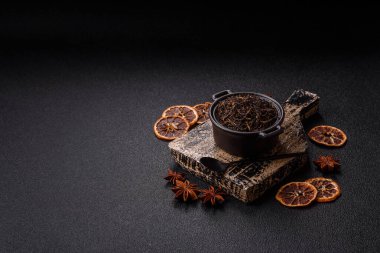 Golden black tea, dried leaves of a Chinese or Indian breakfast drink. Black tea dried leaves as a food backdrop for your design