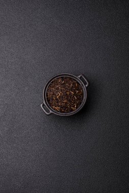 Golden black tea, dried leaves of a Chinese or Indian breakfast drink. Black tea dried leaves as a food backdrop for your design