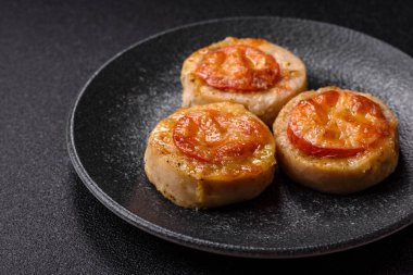 Domates ve peynirle pişirilmiş yuvarlak balık ya da tavuk pirzolası. Tasarımınız için yemek arkaplanı olarak balık pirzolası