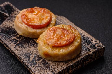 Domates ve peynirle pişirilmiş yuvarlak balık ya da tavuk pirzolası. Tasarımınız için yemek arkaplanı olarak balık pirzolası