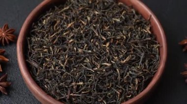 Golden black tea, dried leaves of a Chinese or Indian breakfast drink. Black tea dried leaves as a food backdrop for your design