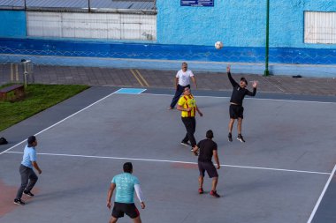 Quito, Ekvador, 3 Haziran 2023: Las Casas sakinleri boş zamanlarını şehir parklarında gayri resmi olarak üç kişi arasında oynanan bir voleybol biçimi olan ecuavoley oynayarak geçirirler..