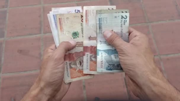 お金の銀行券を数える手コロンビアペソ 南米で最も貧しい国の一つのインフレと経済成長 — ストック動画