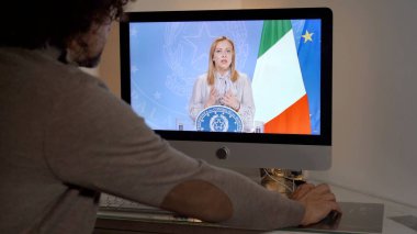 Europe, Milan 2022 - Watching Television News in a laptop computer - Giorgia Meloni the Italian First Lady italian president premier