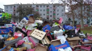 Europe, Italy , Milan 2022 - Giambellino poor neighborhood in suburbs, fruit vegetable market in the street and poor people look for food among the waste of the stalls - economic crisis and poverty
