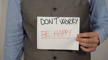 Business man with write Don't worry be happy , Time is now ( carpe diem ) - positive message and lifestyle