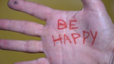 Business man with write Be happy - positive message in hand and lifestyle