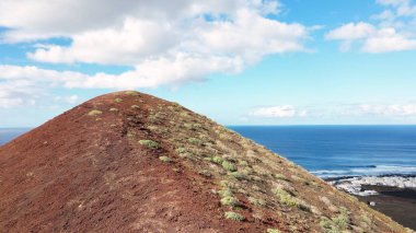Europe, Spain, Lanzarote, Canary Islands - Charco de Los Clicos (Charco Verde) drone aerial view of red volcano in Tymanfaya national park, Volcanic landscape - tourist attraction in biosphere reserve