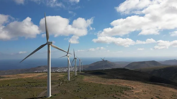 Drone view of mills, wind turbines for the production of clean electricity - green economy and environmental sustainability - save the Planet concept against climate change, global warming - Lanzarote