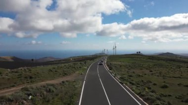 Drone view of mills, wind turbines for the production of clean electricity - green economy and environmental sustainability - save the Planet concept against climate change, global warming - Lanzarote