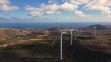 Drone view of mills, wind turbines for the production of clean electricity - green economy and environmental sustainability - save the Planet concept against climate change, global warming - Lanzarote