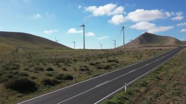 Drone view of mills, wind turbines for the production of clean electricity - green economy and environmental sustainability - save the Planet concept against climate change, global warming - Lanzarote
