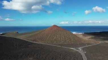 Europe, Spain, Lanzarote, Canary Islands - Charco de Los Clicos (Charco Verde) drone aerial view of red volcano in Tymanfaya national park, Volcanic landscape - tourist attraction in biosphere reserve