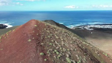 Europe, Spain, Lanzarote, Canary Islands - Charco de Los Clicos (Charco Verde) drone aerial view of red volcano in Tymanfaya national park, Volcanic landscape - tourist attraction in biosphere reserve