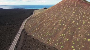 Europe, Spain, Lanzarote, Canary Islands - Charco de Los Clicos (Charco Verde) drone aerial view of red volcano in Tymanfaya national park, Volcanic landscape - tourist attraction in biosphere reserve