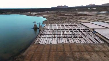 Spain - Drone aerial view of Janubio salt flats mines (Playa del Janubio) in Lanzarote are the largest in the Canary Islands - salt production, pools of seawater dry in the sun, tourist attraction