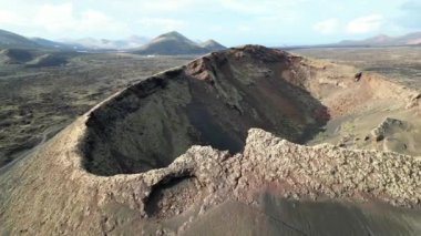 aerial drone view of black lava fields after volcano eruption in volcanic landscape on a Lanzarote island in Spain at Canary Islands, Timanfaya national park biosphere reserve Unesco