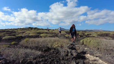 Europe, Spain, Lanzarote, Canary Islands 2023 - Timanfaya national park is a volcanic biosphere reserve tourist attraction - tourists visiting the amazing nature landscape