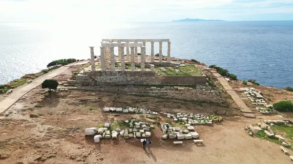 stock image Temple of Poseidon is one of the most famous monuments in Greece, perched on a rocky Cape Sounion overlooking the Mediterranean sea.