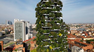 Milan, Italy: 08.28.2024 - drone view of Garibaldi Porta Nuova District in downtown of the city Gae Aulenti BAM new skyline with Unipol, UniCredit skyscrapers and Vertical Forest Bosco verticale.  clipart