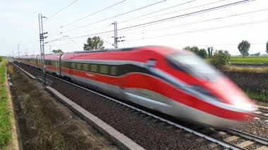 Europe, Italy, Milan 09,14, 2024: Frecciarossa Trenitalia High speed 300 km h train railway view from the drone - the faster way to travel in Italy from Milan to Rome. A1 motorway. clipart